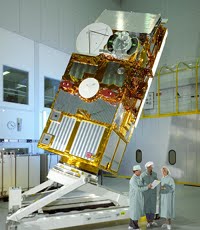 ERS-2 on test 
before 
launch. MSSL’s 
involvement was with the Radar Altimeter, whose large parabolic antenna 
can be seen at the top of the satellite, and with the Along Track 
Scanning Radiometer, whose curved viewing ports can be seen to its 
right. Credit: ESA